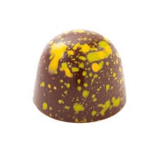 Close-up of handcrafted Dubai chocolate bonbon showing expert technique and precision finishing